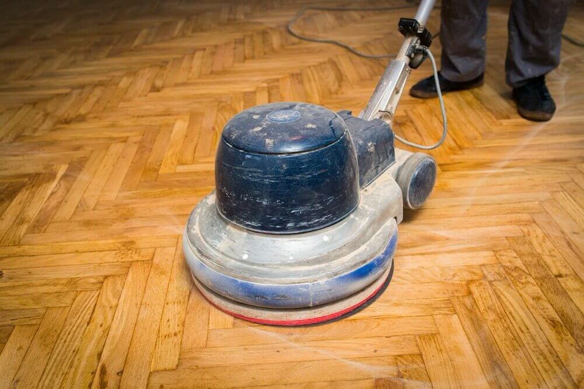 Floor buffing machine working across a hardwood floor