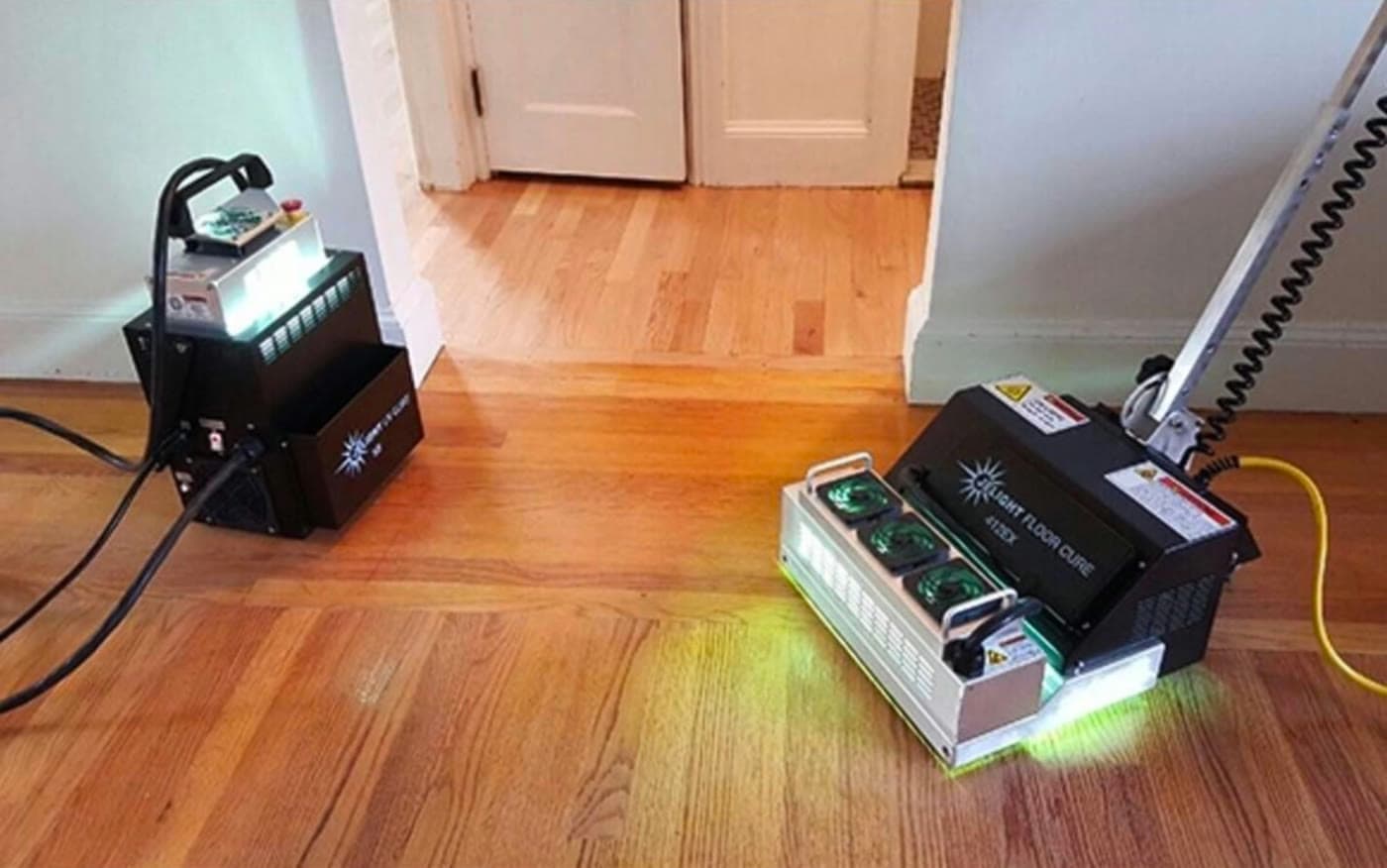 UV curing units running side by side on a hardwood floor